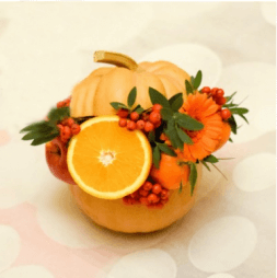 Bouquet of fruit and flower in a pumpkin