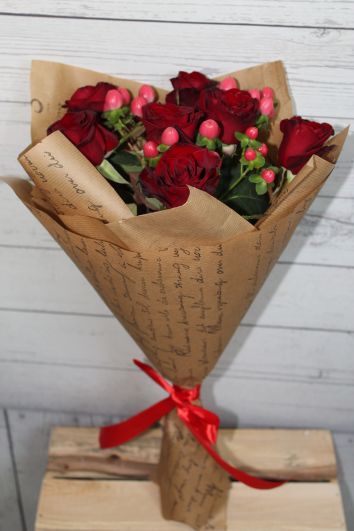 Bouquet of red roses in kraft papper